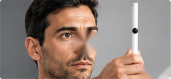 Man watching a dot on a pen held in front of his face